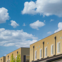 Square White puffy clouds Modern townhouses with rain gutters at Daybreak, Utah