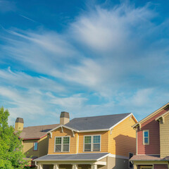 Square Whispy white clouds Home exterior with colorful shingles siding at Daybreak, Utah