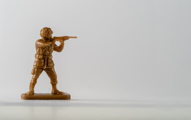 Historical Military soldier toy in brown infantryman with rifle raised to the shoulder