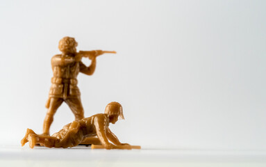 Selected focus crawling comando with out of focus soldier behind  toy soldiers