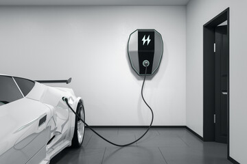 Modern white electric car in a light garage charging with a home electricity power charger on the...