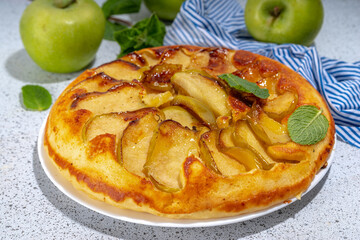 Classic upside-down apple cake. Retro apple cake recipe, cooked in frying pan easy autumn summer homemade baking sweet pastry, with fresh green apples copy space
