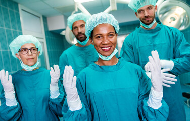 Portrait of a successful medical surgeon team inside operating room