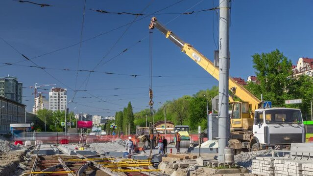 Loader crane for loading and unloading concrete plates on a road construction site timelapse