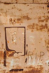 Vintage aged wall with fainted paint and rust colored brown texture with hand engraved letters...