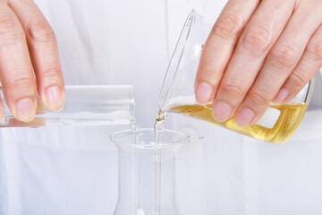 Chemical reagent pouring and mixing, Laboratory and science experiments, Oil formulating the chemical for medical research.