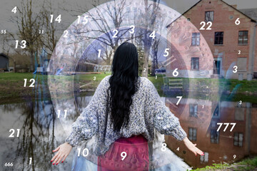 A woman stands in front of an old house surrounded by numbers, numerology
