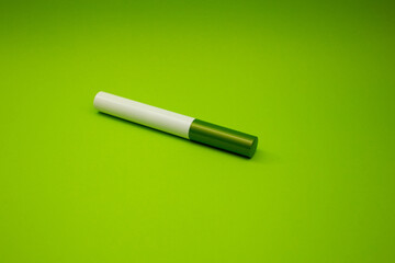 Cosmetic tube on a green background