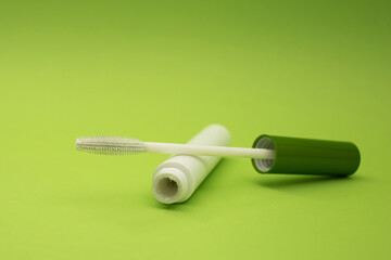 Mascara on a green background, monochrome