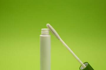 Mascara on a green background, monochrome