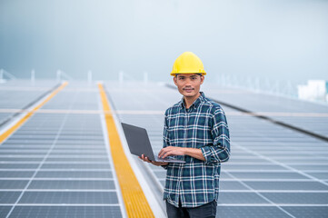 Asia engineer working on roof top soler power plant system renewable energy for future factory or industrial