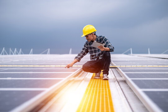Asian engineer working in solar power plant rooftop for control power system eco environmental