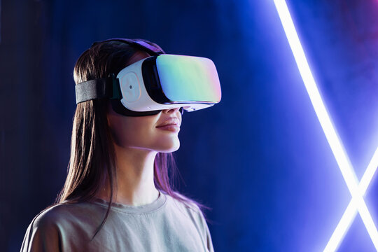 Young woman using virtual reality headset, VR, future, gadgets, technology, education online, studying, video game concept. Closeup portrait of beautiful girl wearing vr glasses.