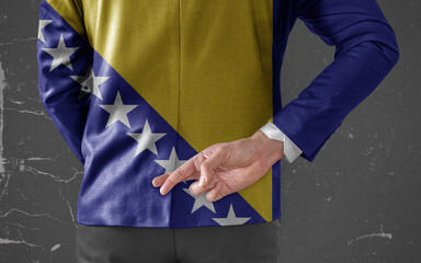 Jacket Flag of Bosnia and Herzegovina on Businessman with his fingers crossed behind his back
