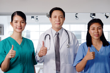 Powerful of Asian chief physician man and surgeon doctor women wears blue and green surgical gown...