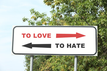 Road sign with different directions - TO HATE or TO LOVE outdoors