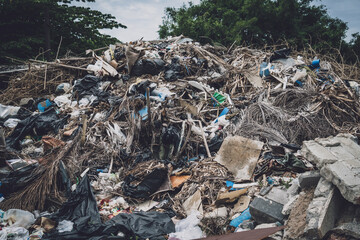 Waste plastic bottles and other types of waste at the ground