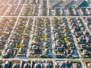 Aerial view of a luxurious village with smooth rows of two-storey duplex houses. Neighborhood in...