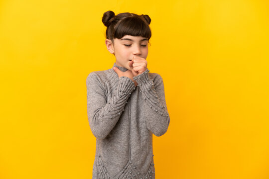 Little caucasian girl isolated on yellow background coughing a lot