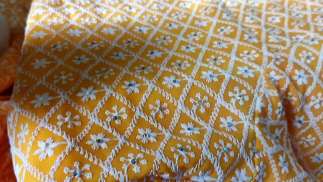 Close up of hand crafted mirror work on fabrics.