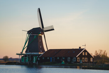 Historical buildings and windmills at dusk in Zaanse Schans, Netherlands