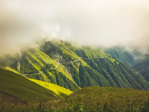 Cinematic Stunning Tusheti Road Panorama With Mist And Green Landscape. Georgian Extreme Tours Adventure Travel