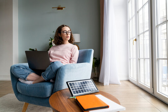 Young freelancer with laptop sitting at home