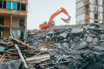 Process of demolition of building. Excavator breaking old house.	
 - obrazy, fototapety, plakaty