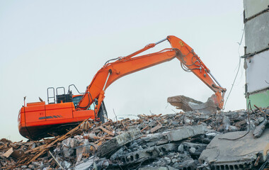 Process of demolition of building. Excavator breaking old house.	
