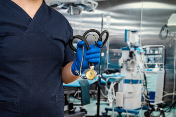 close up of male doctor wear dark blue uniform, stethoscope and gloves  in emergency room