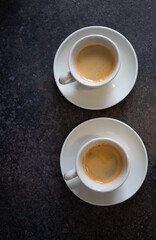 two cups of black coffee on the kitchen table