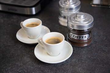 two cups of black coffee on the kitchen table