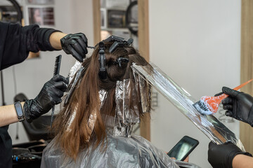 beautiful young woman with dark hair lighten hair special means for coloring curls.