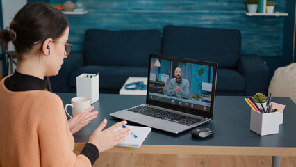 Young woman meeting with teacher on remote video call, talking about online class education and lesson. Student chatting with man on videoconference webinar, using laptop with webcam. - obrazy, fototapety, plakaty