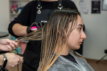 Fototapeta premium a beautiful young woman with a clean perfect face will be pumped hair dye to dye.