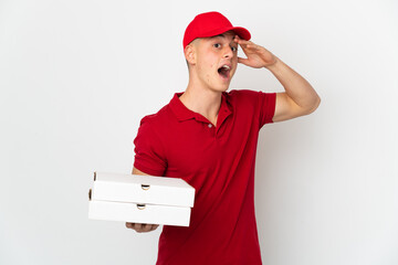 Pizza delivery man with work uniform picking up pizza boxes isolated on white background doing...
