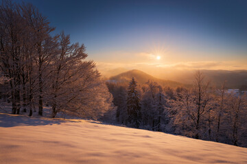 Naklejka na ściany i meble Winter sunrise in Luzicke Mountains