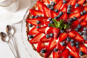 Organic strawberry cake with fresh cream and mint. Festive homemade cheesecake
