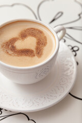 Cup of delicious morning coffee with cinnamon heart