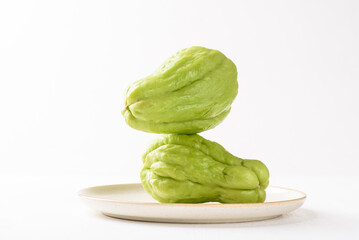 Fresh chayote on white background. Local Asian vegetables are used in vegetarian dishes.