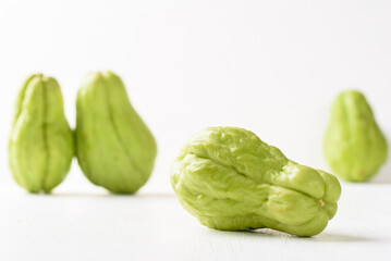 Fresh chayote on white background. Local Asian vegetables are used in vegetarian dishes.