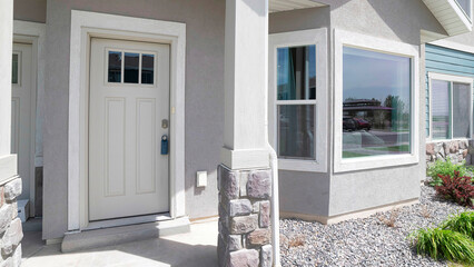 Panorama Townhouse exterior with white front door and bay windows - obrazy, fototapety, plakaty