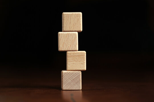 4 Empty Wooden Blocks Stacked High On A Dark Background. For Text Area Copy Area