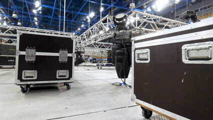 Installation of equipment and spotlights for stage. Stock footage. Preparing stage with bleachers and professional equipment and floodlights before performance or competition - obrazy, fototapety, plakaty