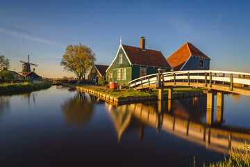 Fototapeta na wymiar Historical buildings and windmills at dawn in Zaanse Schans, Netherlands