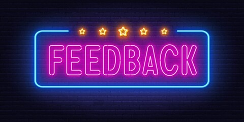 Neon sign Feedback on brick wall background.