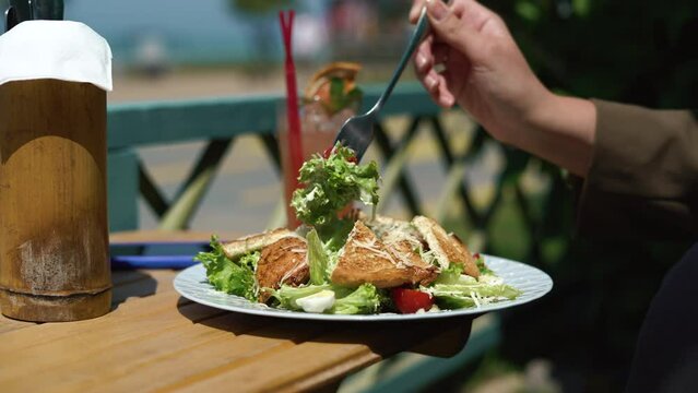 Healthy Lifestyle Woman Eating Fresh Green Salad in outside Restaurant. Sunny day in Georgia. High quality 4k footage