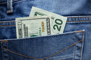 20 dollar bill in the back pocket of jeans, petty expenses and tips concept