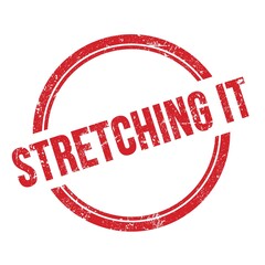 STRETCHING IT text written on red grungy round stamp.