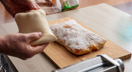 Fresh pasta maker machine. Dough homemade preparation. Hand make dough phylo close up view